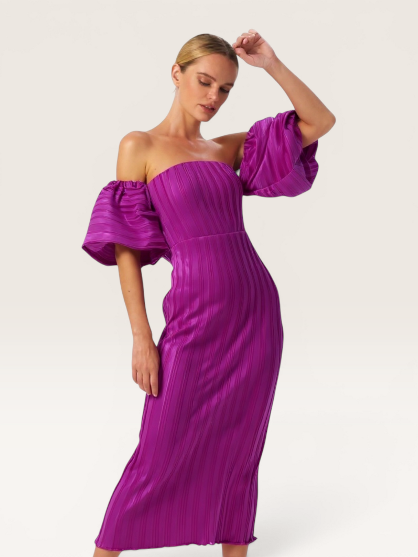 Model wearing a magenta L'IDÉE pleated off-the-shoulder midi dress with puff sleeves from The Runway Reserve